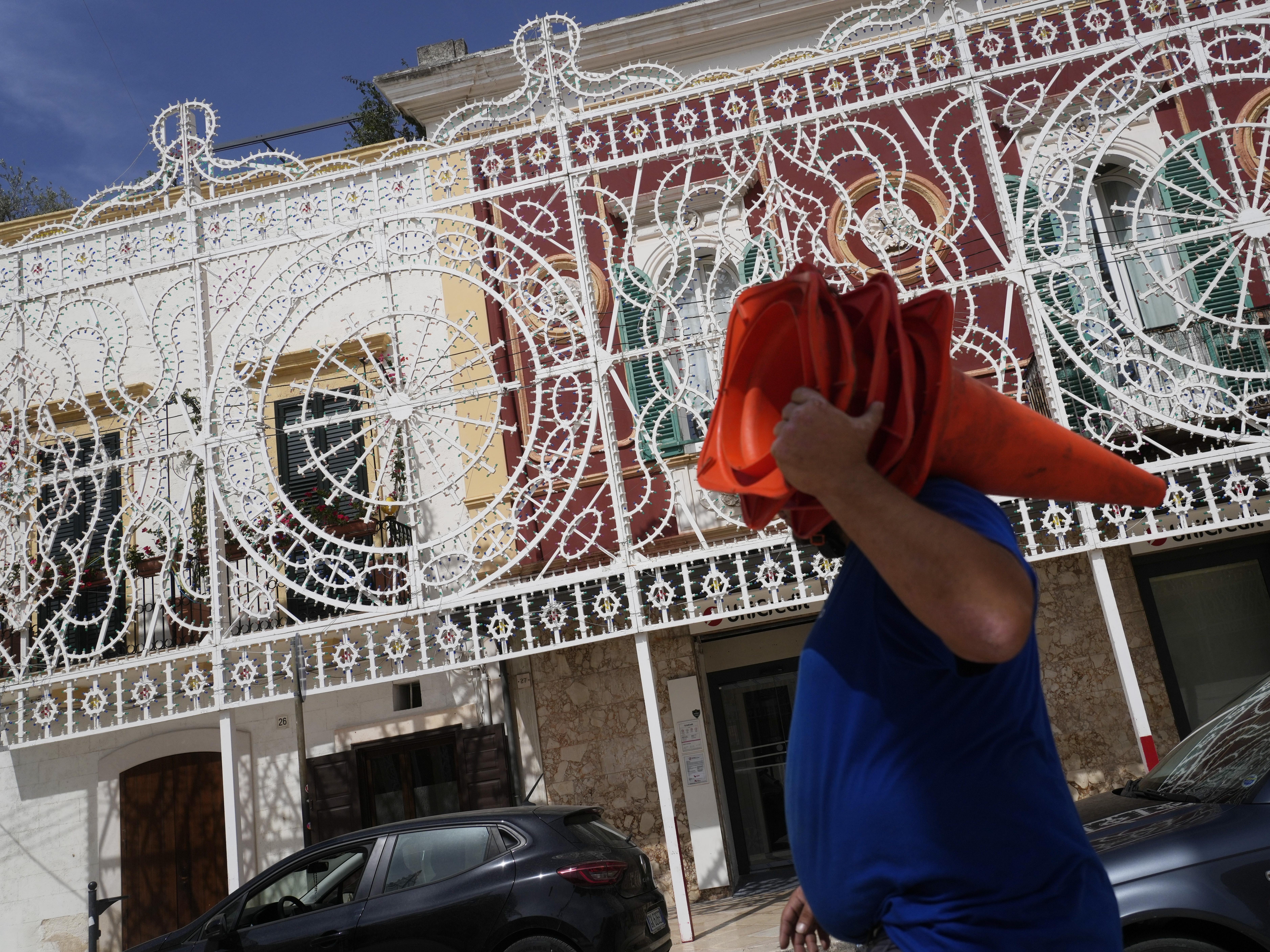 Workers give the finishing touches to the illumination set for the Patron Saint feast in Fasano, near Borgo Egnazia, Italy, on Wednesday, June 12, 2024. A Group of Seven summit aiming to consolidate support for Ukraine opened Thursday under a vastly different political landscape than even a few days ago after European Parliament elections jolted the leaders of France and Germany and emboldened Italian Premier Giorgia Meloni.